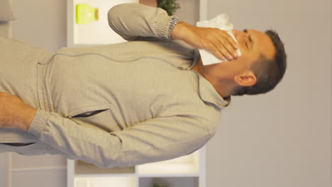 Vertical-video-of-Man-covering-his-mouth-and-nose-while-coughing.